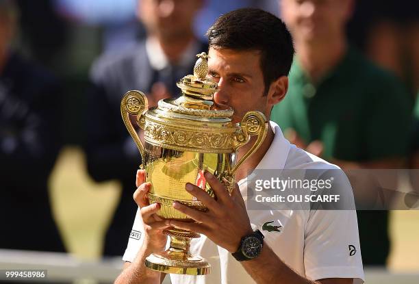 Serbia's Novak Djokovic kisses the winners the trophy after beating South Africa's Kevin Anderson 6-2, 6-2, 7-6 in their men's singles final match on...