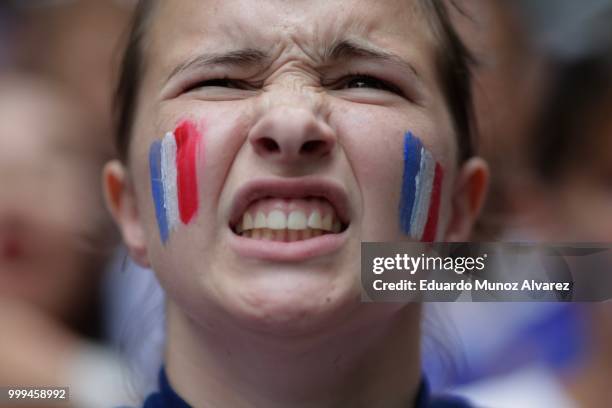 Woman watches the World Cup final soccer match between France and Croatia on July 15, 2018 in New York City. France is seeking its second World Cup...