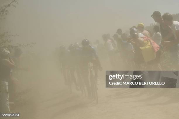 Riders pedal through a cobblestone section during the ninth stage of the 105th edition of the Tour de France cycling race between Arras and Roubaix,...