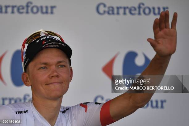 Best climber Latvia's Toms Skujins celebrates on the podium after the ninth stage of the 105th edition of the Tour de France cycling race between...