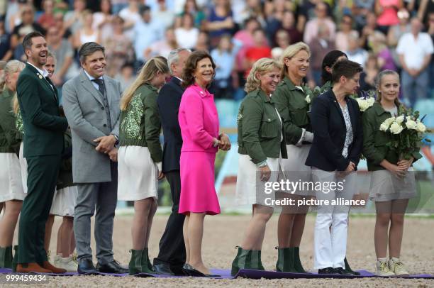 Queen Silvia of Sweden stands on the parcour during the award ceremony after the single show jumping competition of the FEI European Championships...