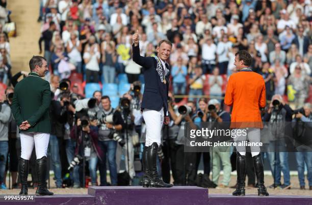 The Irish show jumper Cian O'Connor , Sweden's Peder Fredricson and the Netherland's Harrie Smolders stand on the podium after the single show...