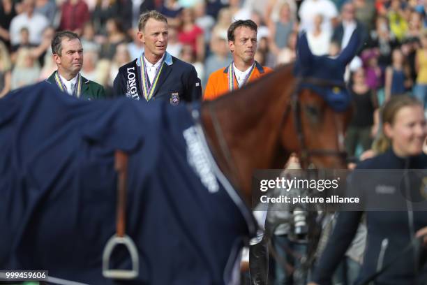 The Irish show jumper Cian O'Connor , Sweden's Peder Fredricson and the Netherland's Harrie Smolders stand on the podium after the single show...