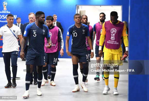 Samuel Umtiti, Kylian Mbappe and Steve Mandanda of France make their way to the pitch for second half during the 2018 FIFA World Cup Final between...
