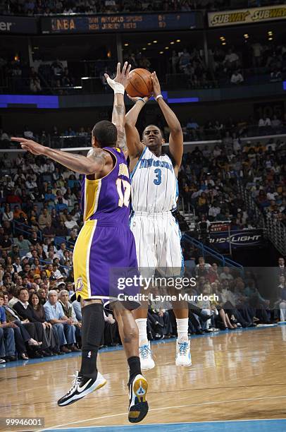 Chris Paul of the New Orleans Hornets takes a jumpshot against Andrew Bynum of the Los Angeles Lakers on March 29, 2010 at the New Orleans Arena in...