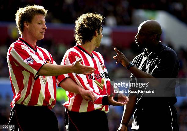 Stefan Schwarz and Julio Arca of Sunderland are spoken to by referee Uriah Rennie during the Aston Villa v Sunderland FA Barclaycard Premiership...