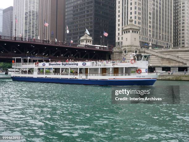 View of a Shoreline Sightseeing boat passing under the DuSable Bridge on a tour of the Chicago River, Chicago, Illinois, 2018.