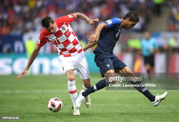 Raphael Varane of France tackles Adil Rami of France during the 2018 FIFA World Cup Final between France and Croatia at Luzhniki Stadium on July 15,...