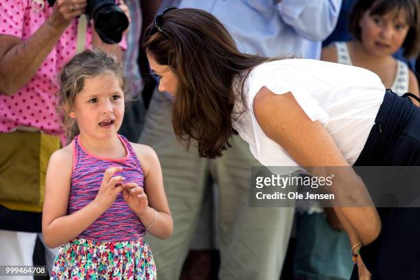 Crown Princess Mary of Denmark talks to a young bystander during the Tilting-At-The-Ring Riders Event at Graasten Castle at Graasten on July 15, 2018...