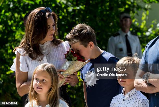 Crown Princess Mary Princess tease Prince Christian with a flower bouquet during he Tilting-At-The-Ring Riders Event at Graasten Castle at Graasten...