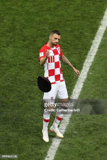 Marcelo Brozovic of Croatia throws a pitch invaders hat off the pitch during the 2018 FIFA World Cup Final between France and Croatia at Luzhniki...