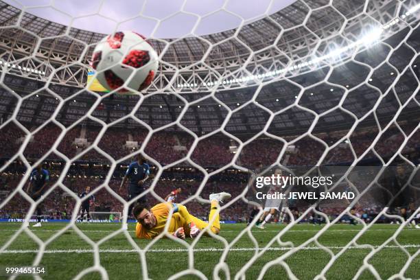 France's goalkeeper Hugo Lloris watches the ball after conceding during the Russia 2018 World Cup final football match between France and Croatia at...