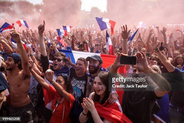 French football fans gather in the Champs-de-Mars fan zone, in front of the Eiffel Tower, to watch the FIFA 2018 World Cup Final match between France...
