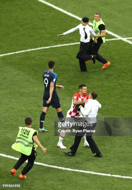 Pitch invaders are chased by the security staff during the 2018 FIFA World Cup Final between France and Croatia at Luzhniki Stadium on July 15, 2018...