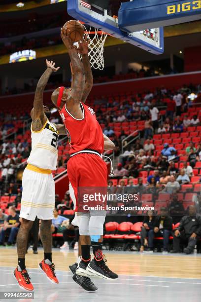 Al Harrington of Trilogy goes in for a layup against Josh Powell of the Killer 3s during BIG3 - Week Four on July 13, 2018 at Little Caesars Arena in...