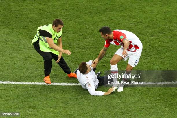 Pitch invader is stopped by Dejan Lovren of Croatia during the 2018 FIFA World Cup Final between France and Croatia at Luzhniki Stadium on July 15,...