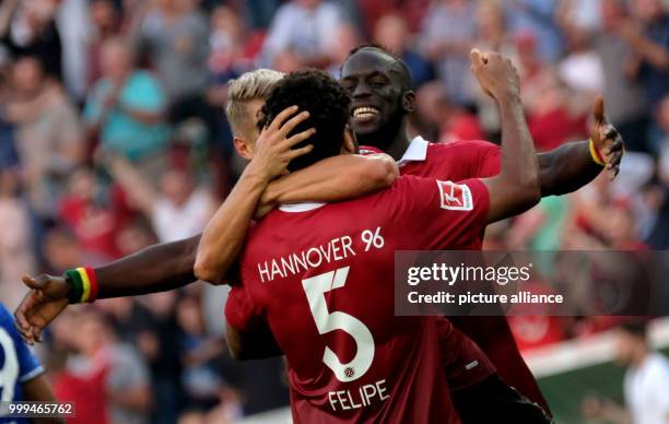 Hannover's Felipe , Matthias Ostrzolek and Salif Sane celebrate after the ending of the German Bundesliga soccer match between Hannover 96 and FC...