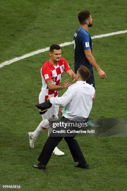 Dejan Lovren of Croatia confronts a pitch invader during the 2018 FIFA World Cup Final between France and Croatia at Luzhniki Stadium on July 15,...