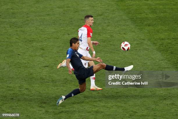 Raphael Varane of France controls the ball ahead of Ivan Perisic of Croatia during the 2018 FIFA World Cup Final between France and Croatia at...