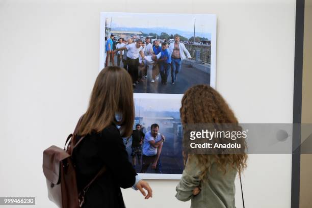 People visit photography exhibition, organized with the photographs from Turkey's Anadolu Agency about the July 15th failed coup attempt in Turkey,...