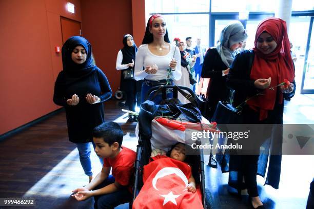 People attend a ceremony during the July 15 Democracy and National Unity Day to mark July 15 defeated coup's 2nd anniversary at Turkish Embassy in...