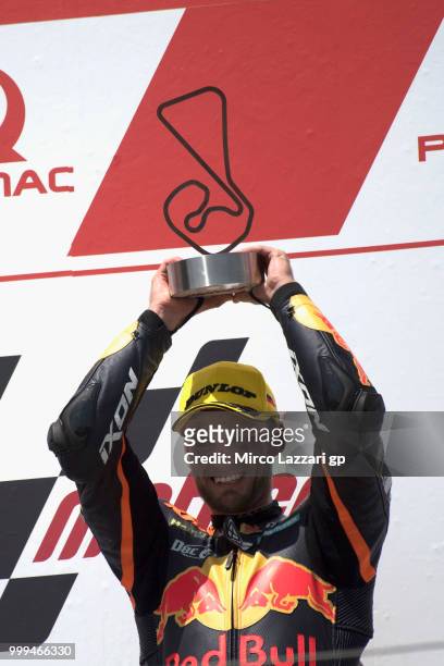 Brad Binder of South Africa and Red Bull KTM Ajo celebrates the victory on the podium at the end of the moto2 race during the MotoGp of Germany -...