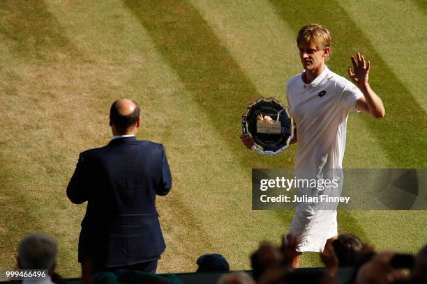 Runner-up Kevin Anderson of South Africa waves to the crowd during the trophy presentation after the Men's Singles final against Novak Djokovic of...