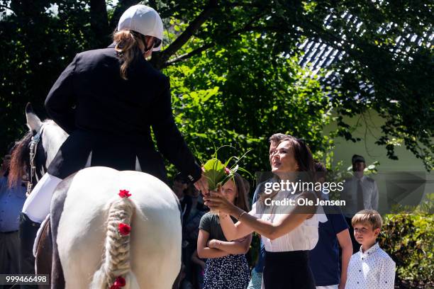 Crown Princess Mary of Denmark receives a flower bouquet during the Tilting-At-The-Ring Riders Event at Graasten Castle at Graasten on July 15, 2018...