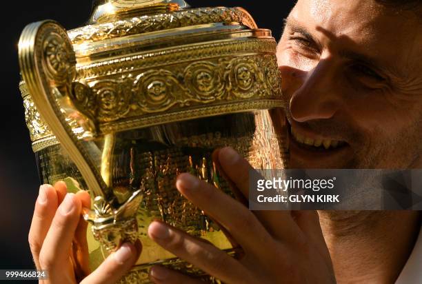 Serbia's Novak Djokovic poses with the winners trophy after beating South Africa's Kevin Anderson 6-2, 6-2, 7-6 in their men's singles final match on...