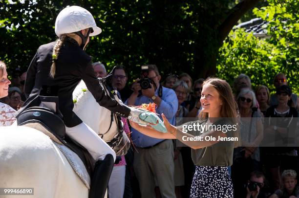 Princess Isabella receives flowers from a young rider at the Tilting-At-The-Ring Riders Event at Graasten Castle at Graasten on July 15, 2018 in...