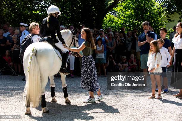 Princess Isabella receives flowers from a young rider at the Tilting-At-The-Ring Riders Event at Graasten Castle at Graasten on July 15, 2018 in...