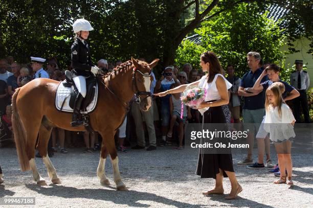 Crown Princess Mary of Denmark receives a flower bouquet during the Tilting-At-The-Ring Riders Event at Graasten Castle at Graasten on July 15, 2018...