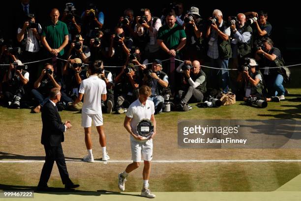 Novak Djokovic of Serbia and Kevin Anderson of South Africa with their trophies after the Men's Singles final on day thirteen of the Wimbledon Lawn...