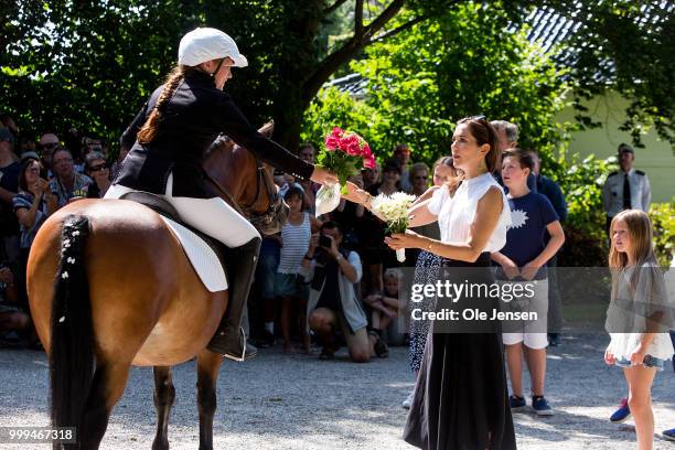 Crown Princess Mary of Denmark receives a flower bouquet during the Tilting-At-The-Ring Riders Event at Graasten Castle at Graasten on July 15, 2018...