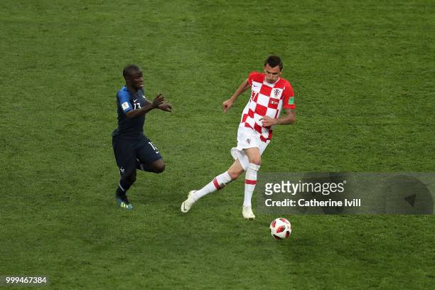 Mario Mandzukic of Croatia is challenged by Ngolo Kante of France during the 2018 FIFA World Cup Final between France and Croatia at Luzhniki Stadium...