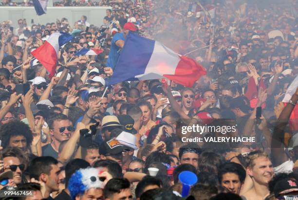 Supporters of the French national football team react as they watch the Russia 2018 World Cup final football match between France and Croatia, on...