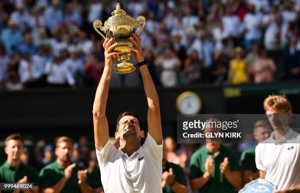 Serbia's Novak Djokovic holds up the winners trophy after beating South Africa's Kevin Anderson 6-2, 6-2, 7-6 in their men's singles final match on...