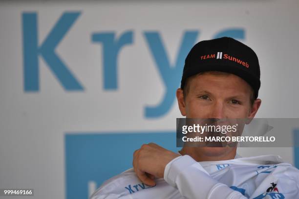 Denmark's Soren Kragh Andersen puts on the best young's white jersey on the podium after the ninth stage of the 105th edition of the Tour de France...