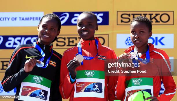 Peruth Chemutai of Uganda, Celiphine Chepteek Chepsol of Kenya and Winfred Mutile Yavi of Bahrain celebrate with their medals during the medal...