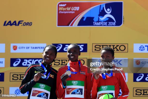 Peruth Chemutai of Uganda, Celiphine Chepteek Chepsol of Kenya and Winfred Mutile Yavi of Bahrain celebrate with their medals during the medal...