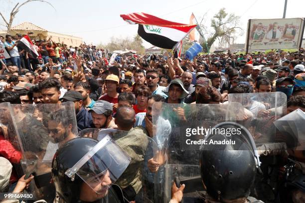 Iraqi security forces take security measures as Iraqi citizens gather to protest government due to lack of basic services and frequent power outages...