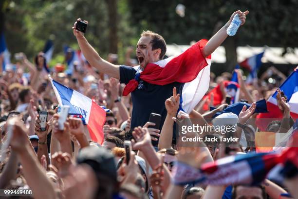 French football fans gather in the Champs-de-Mars fan zone, in front of the Eiffel Tower, to watch the FIFA 2018 World Cup Final match between France...