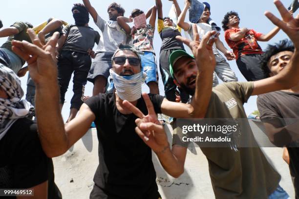 Iraqi citizens gather to protest against government due to lack of basic services and frequent power outages in front of the governor's building in...