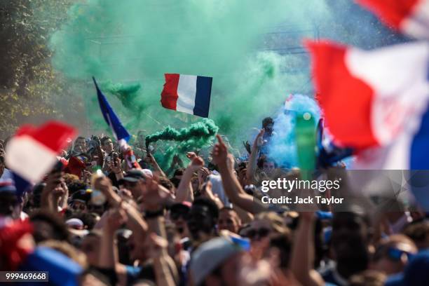 French football fans gather in the Champs-de-Mars fan zone, in front of the Eiffel Tower, to watch the FIFA 2018 World Cup Final match between France...