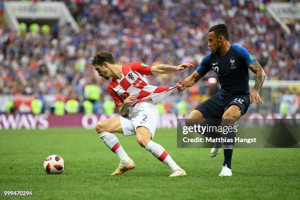 Sime Vrsaljko of Croatia is challenged by Corentin Tolisso of France during the 2018 FIFA World Cup Final between France and Croatia at Luzhniki...