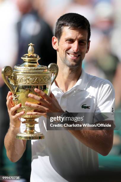 Mens Singles Final - Novak Djokovic v Kevin Anderson - Novak Djokovic poses with the winners trophy at All England Lawn Tennis and Croquet Club on...