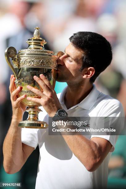 Mens Singles Final - Novak Djokovic v Kevin Anderson - Novak Djokovic poses with the winners trophy at All England Lawn Tennis and Croquet Club on...