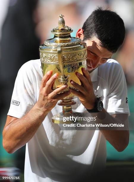 Mens Singles Final - Novak Djokovic v Kevin Anderson - Novak Djokovic poses with the winners trophy at All England Lawn Tennis and Croquet Club on...