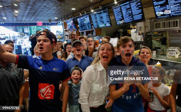 French fans react as France scores a goal, as they watch the World Cup final match between France vs Croatia on July 15, 2018 in New York. - The...