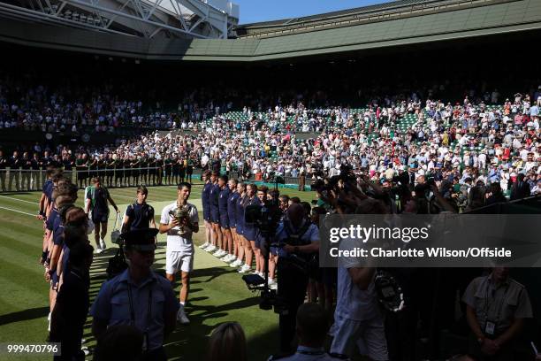 Mens Singles Final - Novak Djokovic v Kevin Anderson - A general view of Centre Court as Novak Djokovic walks down a tunnel of ball boys with the...